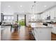 Open-concept kitchen with granite countertops, bar seating, and stainless-steel appliances at 5779 Piney River Pl, Brighton, CO 80601