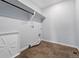 Functional laundry room with tile flooring, shelving, and all necessary hookups at 5779 Piney River Pl, Brighton, CO 80601
