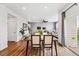 Open-concept living room and dining area with hardwood floors and modern decor at 5779 Piney River Pl, Brighton, CO 80601