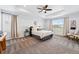 Calming main bedroom featuring tray ceiling, plush carpet, and ample natural light at 5779 Piney River Pl, Brighton, CO 80601
