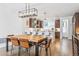 Open concept dining area with modern wooden table, adjacent to kitchen at 2471 Walnut St, Boulder, CO 80302