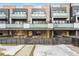 Modern townhome with a yellow front door and a sleek, fenced yard at 2471 Walnut St, Boulder, CO 80302