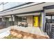 Inviting front porch with yellow door and two comfy chairs at 2471 Walnut St, Boulder, CO 80302