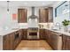 Modern kitchen with stainless steel appliances and wooden cabinets at 2471 Walnut St, Boulder, CO 80302