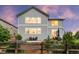 A beautifully landscaped backyard with a retaining wall, patio furniture, and a well-maintained lawn at 5984 S Paris Pl, Greenwood Village, CO 80111