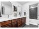 Bathroom featuring a double vanity with a marble countertop and two mirrors on the wall at 5984 S Paris Pl, Greenwood Village, CO 80111