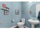 Charming powder room featuring blue walls, updated fixtures and decor at 5984 S Paris Pl, Greenwood Village, CO 80111