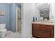 Bathroom with a vanity on the right and a tiled shower on the left at 5984 S Paris Pl, Greenwood Village, CO 80111