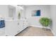 Bathroom featuring a double vanity with granite countertop and decorative accents at 5984 S Paris Pl, Greenwood Village, CO 80111