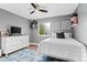 Bedroom featuring a ceiling fan, a window with natural light, and carpeted floors at 5984 S Paris Pl, Greenwood Village, CO 80111