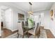 Bright dining room featuring a glass table, modern light fixture and neutral decor at 5984 S Paris Pl, Greenwood Village, CO 80111