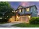 Charming two-story home with a three-car garage, brick accents, neutral siding, and a well-manicured lawn at 5984 S Paris Pl, Greenwood Village, CO 80111