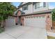 A three-car garage home with brick accents and a gray exterior offers ample parking and curb appeal at 5984 S Paris Pl, Greenwood Village, CO 80111