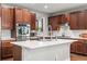 Kitchen with wooden cabinets, stainless steel appliances, a kitchen island with a white countertop, and hardwood floors at 5984 S Paris Pl, Greenwood Village, CO 80111
