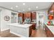 A modern kitchen featuring a large island, stainless steel appliances, wooden cabinets, and a bright, open layout at 5984 S Paris Pl, Greenwood Village, CO 80111