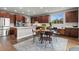 A kitchen with stainless steel appliances, wood cabinets, a large kitchen island, and an attached dining table at 5984 S Paris Pl, Greenwood Village, CO 80111