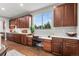 Kitchen with ample counter space, wood cabinets, and a built-in desk area by the window at 5984 S Paris Pl, Greenwood Village, CO 80111
