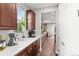 Spacious kitchen showcasing generous counter space, wooden cabinetry, stainless steel appliances, and hardwood floors at 5984 S Paris Pl, Greenwood Village, CO 80111