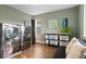 A modern laundry room with large capacity front-load washer and dryer, plus plenty of storage at 5984 S Paris Pl, Greenwood Village, CO 80111