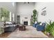 Inviting living room features high ceilings, large windows, a fireplace, and hardwood floors at 5984 S Paris Pl, Greenwood Village, CO 80111