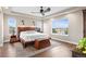 Spacious bedroom with ceiling fan, hardwood floors, and large window overlooking the neighborhood at 5984 S Paris Pl, Greenwood Village, CO 80111