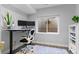 Bright home office with a desk, dual monitors, and a view to the window well at 5984 S Paris Pl, Greenwood Village, CO 80111