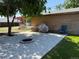 A backyard featuring a stamped concrete patio with a fire pit and a grassy area at 1000 Denver Ave, Fort Lupton, CO 80621