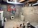 Unfinished basement with concrete walls, a light, storage, and other materials at 1000 Denver Ave, Fort Lupton, CO 80621