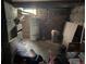 Unfinished basement featuring exposed brick, water heater, and storage space at 1000 Denver Ave, Fort Lupton, CO 80621