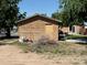 An exterior shot of a shed shows the front door and a pile of debris at 1000 Denver Ave, Fort Lupton, CO 80621