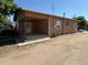 Rustic home featuring covered porch and gravel yard at 1000 Denver Ave, Fort Lupton, CO 80621