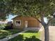 Charming single-story home with a covered front porch and mature trees at 1000 Denver Ave, Fort Lupton, CO 80621