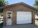Exterior garage shows peeling paint and old door at 1000 Denver Ave, Fort Lupton, CO 80621