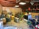 The interior of a garage contains multiple tools, lawn care equipment and other household items at 1000 Denver Ave, Fort Lupton, CO 80621