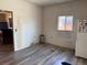 Kitchen area with laminate flooring and white appliances at 1000 Denver Ave, Fort Lupton, CO 80621