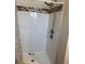 Updated shower with shower head, new tiling and updated shower fixtures at 1000 Denver Ave, Fort Lupton, CO 80621