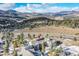 Aerial view showcasing condo location near highway and mountains at 31819 Rocky Village Dr # 216, Evergreen, CO 80439