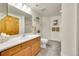 Full bathroom with wood cabinets and updated toilet at 31819 Rocky Village Dr # 216, Evergreen, CO 80439