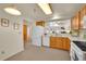 Kitchen with light wood cabinets, white appliances, and a breakfast bar at 31819 Rocky Village Dr # 216, Evergreen, CO 80439