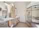 Bright bathroom features double sinks, shower, tub and modern cabinets at 33448 Alta Vista Dr, Evergreen, CO 80439