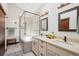 Well-lit bathroom featuring a walk-in shower and a double vanity at 33448 Alta Vista Dr, Evergreen, CO 80439