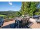 Outdoor deck features comfortable seating, a grill, and stunning mountain views at 33448 Alta Vista Dr, Evergreen, CO 80439
