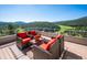 Enjoy outdoor living on this private deck with seating and panoramic mountain views at 33448 Alta Vista Dr, Evergreen, CO 80439