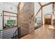 Stunning entryway featuring wood accents, large windows, and hardwood floors with an open view into other living spaces at 33448 Alta Vista Dr, Evergreen, CO 80439