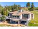 Stunning home showcasing a tile roof, multiple balconies, and panoramic views at 33448 Alta Vista Dr, Evergreen, CO 80439