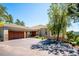 Charming home featuring a tile roof, stone accents, and a spacious three-car garage at 33448 Alta Vista Dr, Evergreen, CO 80439