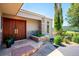 Inviting front entrance featuring a stone planter, flagstone path, and double wood doors at 33448 Alta Vista Dr, Evergreen, CO 80439