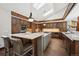 Spacious kitchen featuring an island with seating, stainless steel appliances, and ample custom cabinetry at 33448 Alta Vista Dr, Evergreen, CO 80439