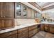 Gourmet kitchen featuring marble counters, designer backsplash and custom wood cabinetry at 33448 Alta Vista Dr, Evergreen, CO 80439
