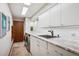 Functional laundry room with ample counter space, modern appliances, and sleek white cabinets for efficient chores at 33448 Alta Vista Dr, Evergreen, CO 80439